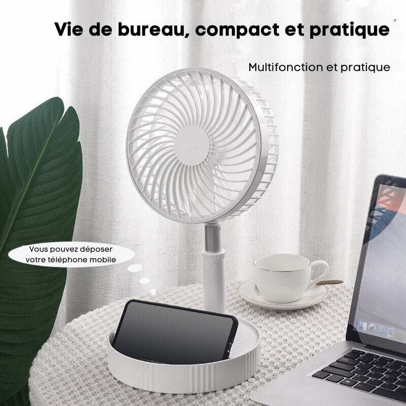 Ventilateur portable FoldAir sur une table, idéal pour la maison ou le bureau, avec un support pour téléphone.